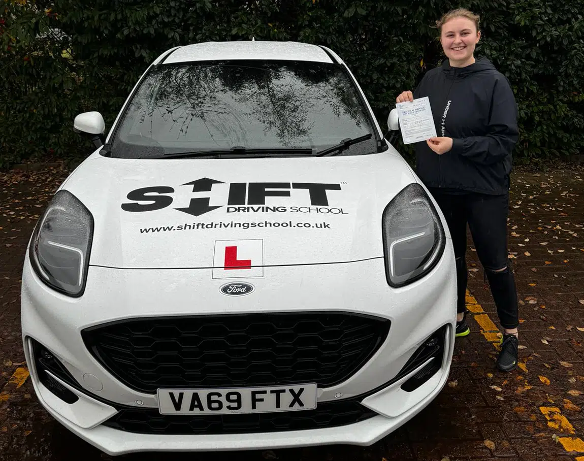 Emily's Pass picture with Shift Driving School's White Ford Puma Learner Car
